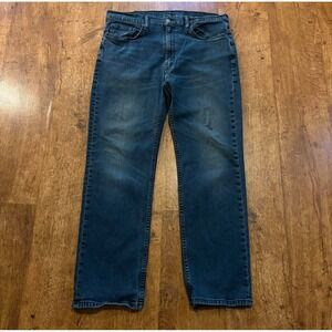 faded Levi's 514 blue jeans size 38x30 with distressed areas, straight-leg
